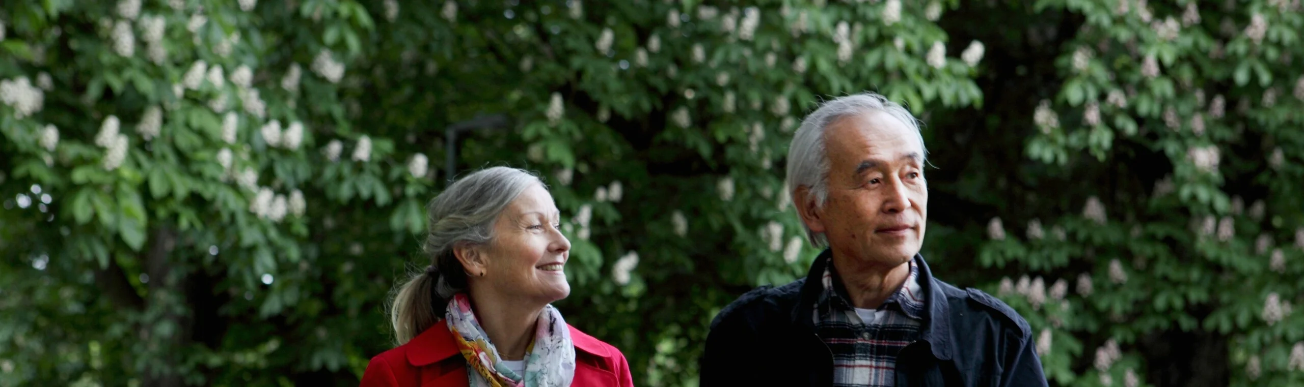 Older couple walking in park