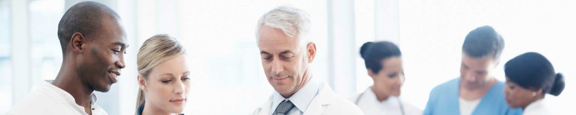 Group of successful doctors discussing patient's report at the hospital