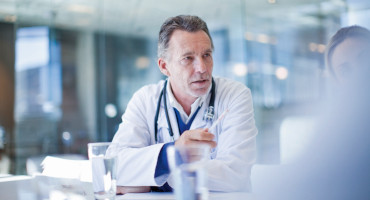 Senior doctor and colleagues meeting in conference room