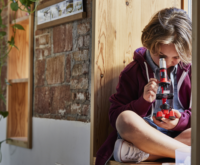 Kid looking through a microscope