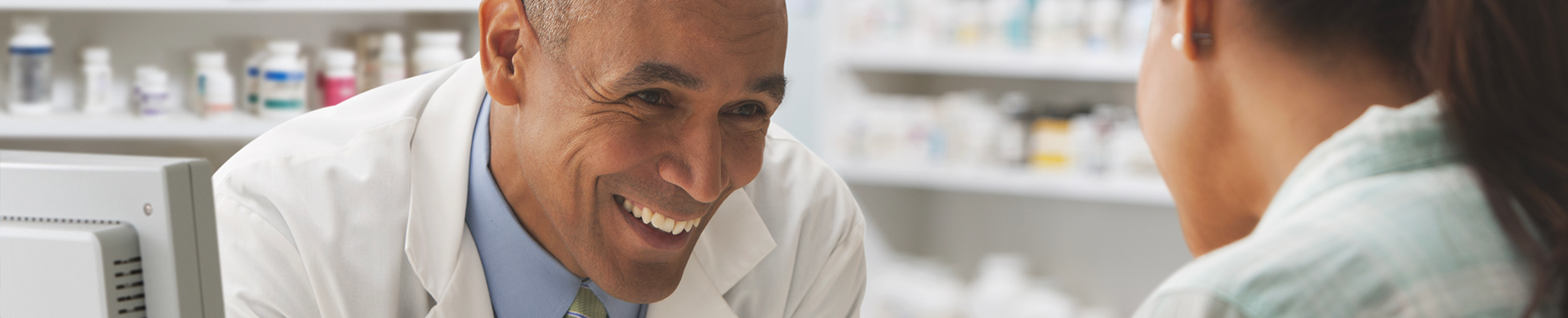 Chemist in light conversation with patient/customer.