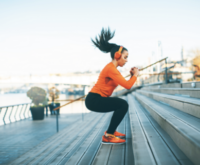 A young female engaged in intensive exercise outdoors