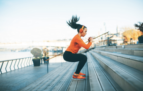 A young female engaged in intensive exercise outdoors