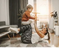Mother playing with son in the living room