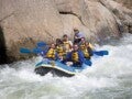 A group of people enjoying river rafting.