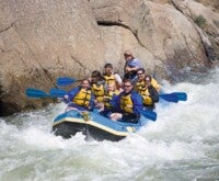 A group of people enjoying river rafting.