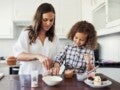 A young lady with a child baking gourmet treats