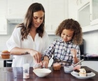 A young lady with a child baking gourmet treats