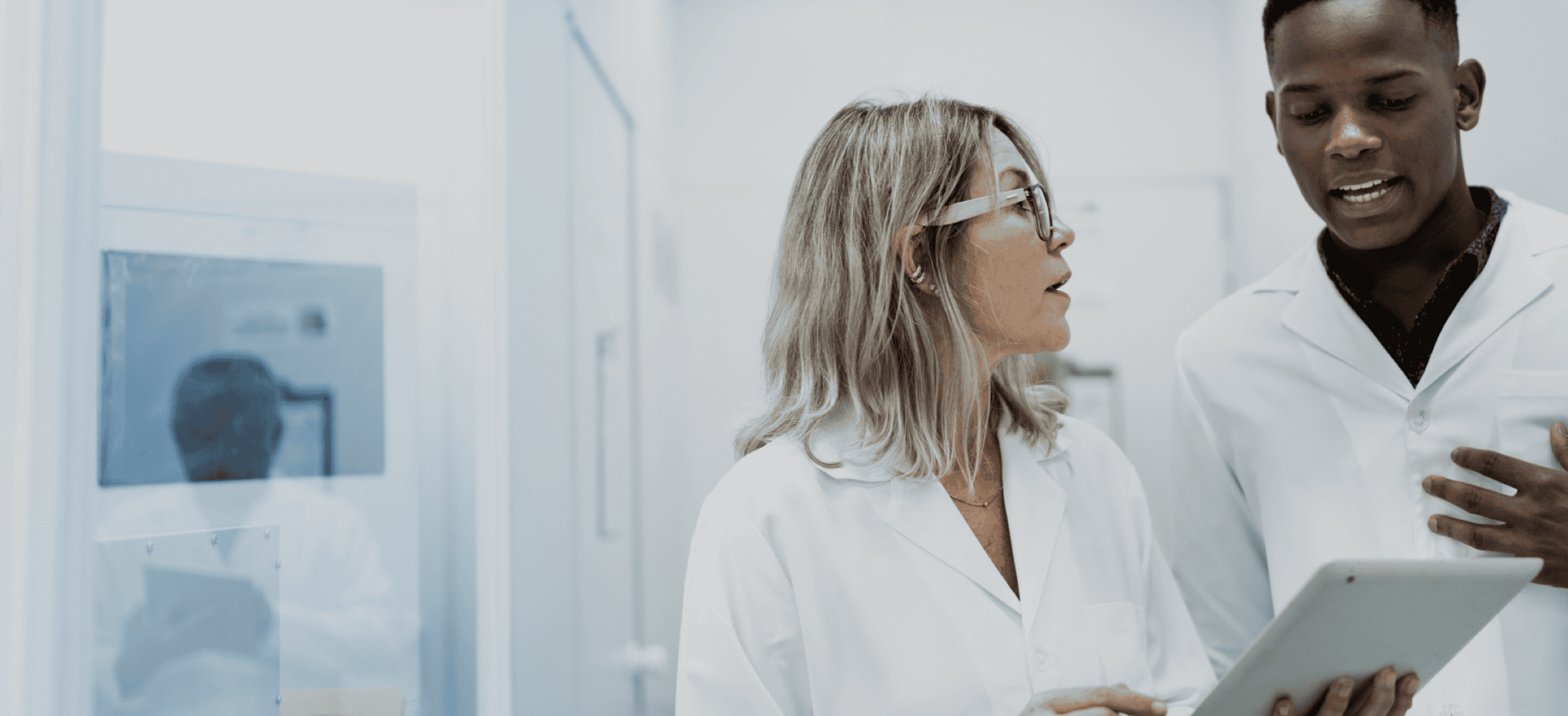 Homepage image - A researcher talking to her colleague, while looking at an iPad