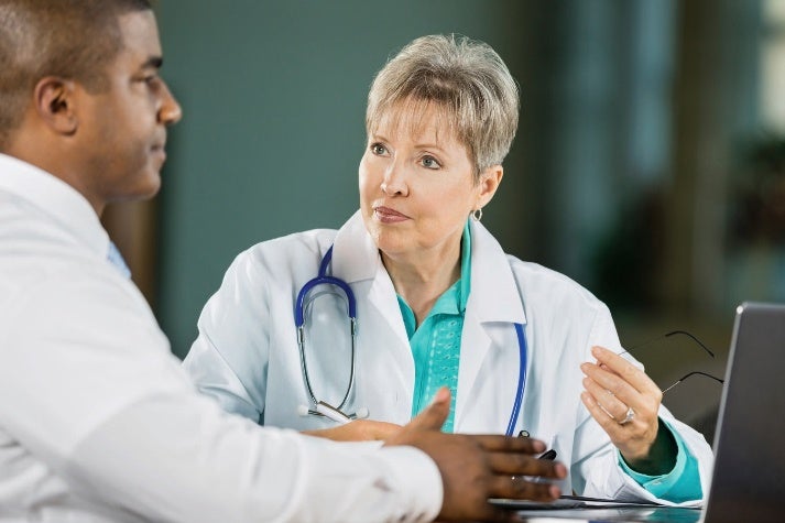 Healthcare professionals discussing hospital policy in meeting