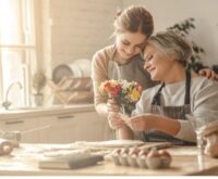 A beautiful moment between a middle-aged mother and a young adult daughter.