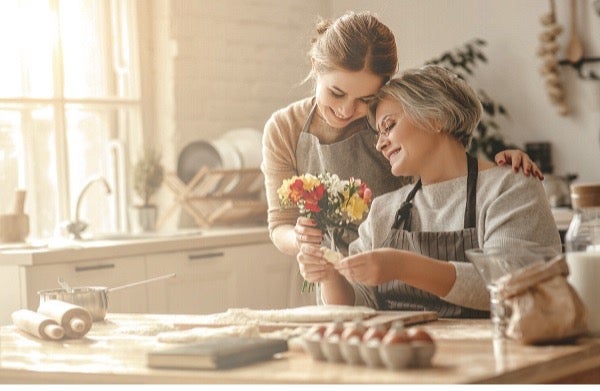 A beautiful moment between a middle-aged mother and a young adult daughter.