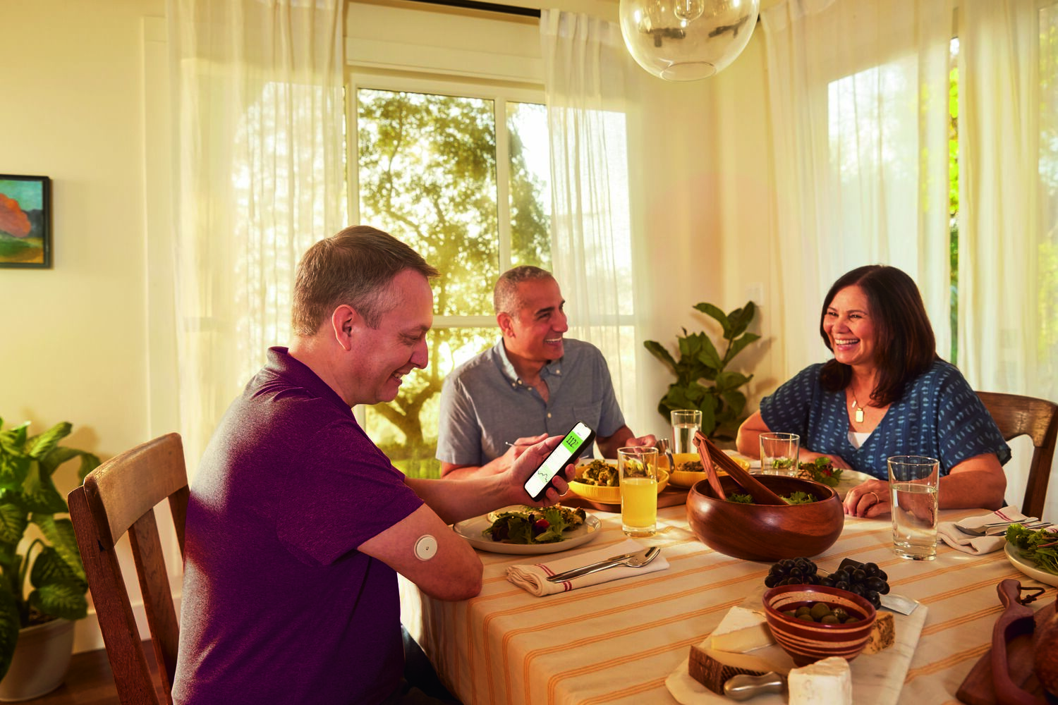 A family at dining table eating and conversing together.