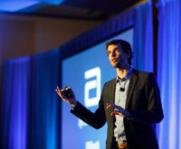 A conference speaker engaging the audience during his presentation