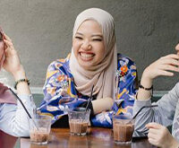 Asian women enjoying coffee together