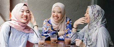 Asian women enjoying coffee together