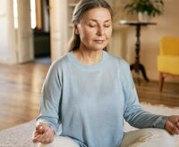 A lady sitting calmly closed eyes in her house