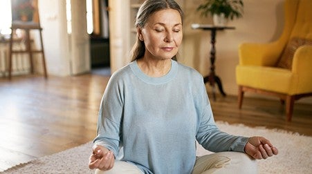 A lady sitting calmly closed eyes in her house