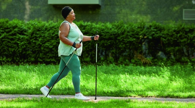 Woman walking outdoors to support cardiometabolic health